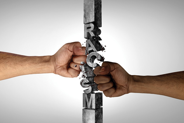 White and black hands smashing the word